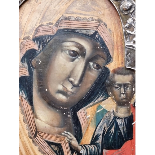 1657 - A good late 18th century Russian silver gilt mounted icon of Virgin and Child, tempera on wood panel... 