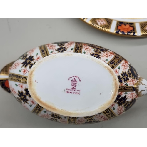 1680 - A Royal Crown Derby Imari sauce boat and stand. 