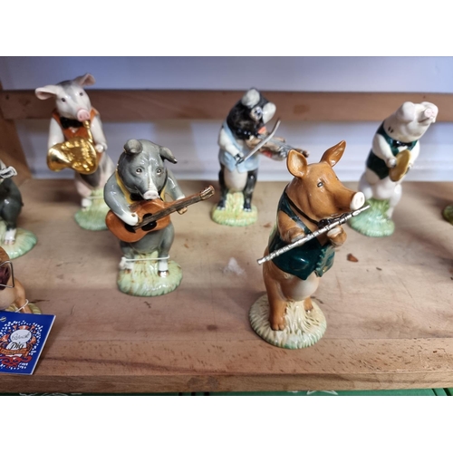 1730 - A set of eight Beswick pig musicians; together with two other Beswick figures, each boxed. (10)... 