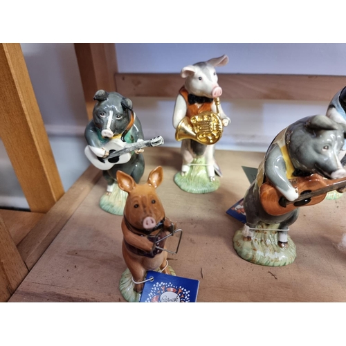 1730 - A set of eight Beswick pig musicians; together with two other Beswick figures, each boxed. (10)... 