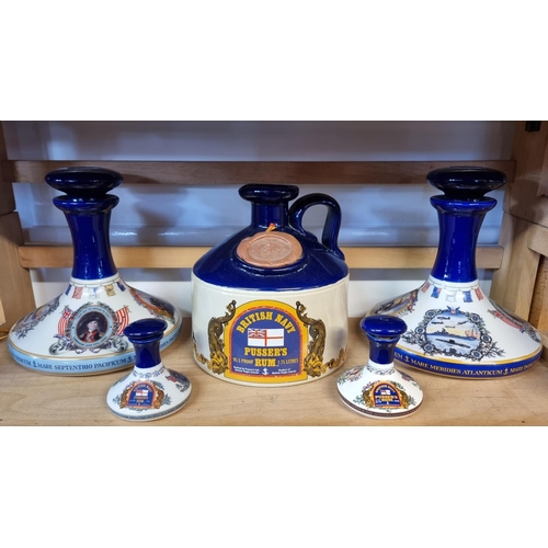 1740 - Two pairs of Pusser's rum decanters and stoppers, largest 22cm high; and a similar flagon. (5)... 