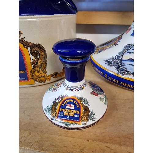 1740 - Two pairs of Pusser's rum decanters and stoppers, largest 22cm high; and a similar flagon. (5)... 