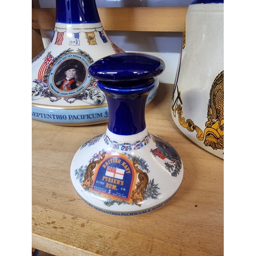 1740 - Two pairs of Pusser's rum decanters and stoppers, largest 22cm high; and a similar flagon. (5)... 