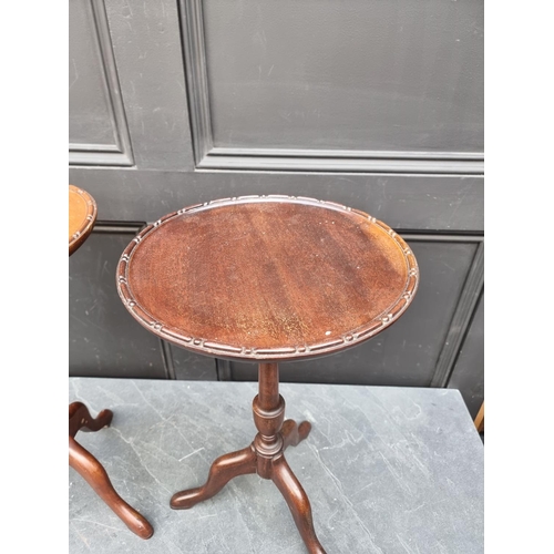 1032 - Two similar small mahogany reproduction tripod tables, largest 51.5cm high.