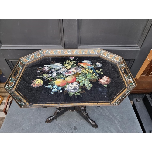 1096 - A 19th century toleware tray, 70cm wide; on associated ebonized tripod stand.