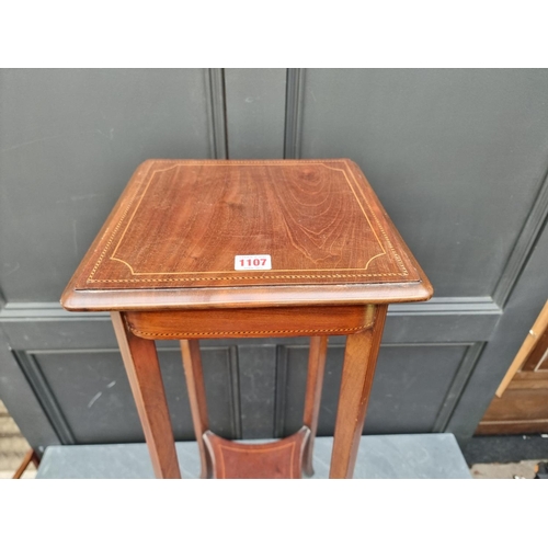 1107 - An Edwardian mahogany, chequer and line inlaid torchere, 90cm high.