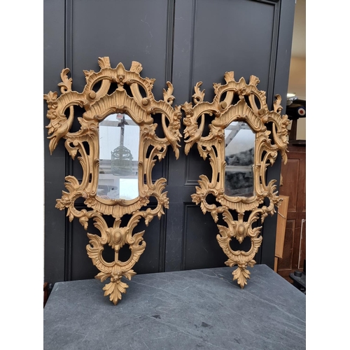 1112 - A pair of rococo style card giltwood frame wall mirrors, 114 x 67cm. (2)