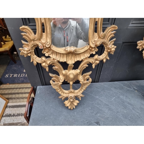 1112 - A pair of rococo style card giltwood frame wall mirrors, 114 x 67cm. (2)