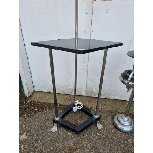 1228 - An Art Deco chrome and ebonized adjustable lamp table; together with a similar smokers stand, 7... 