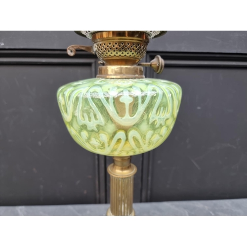 1513 - A Victorian brass and vaseline oil lamp, height excluding chimney 56cm.