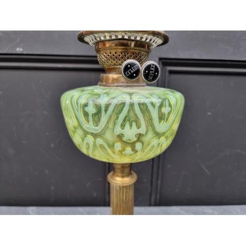 1513 - A Victorian brass and vaseline oil lamp, height excluding chimney 56cm.