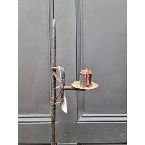 1532 - An antique wrought iron tripod candle stick, 85cm high.