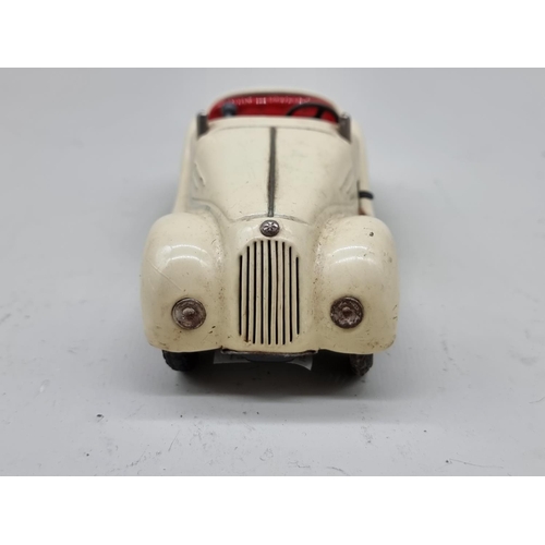 1830 - Schuco: a vintage (1950s) cream Examico 4001 clockwork car, (no key, base partially detached).... 