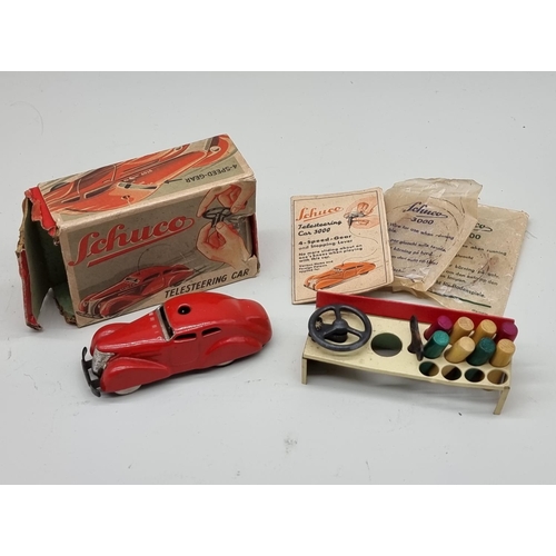 1833 - Schuco: a vintage red Schuco Telesteering car 3000, with box, key, instructions and accessories... 