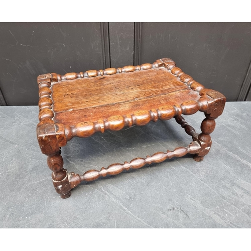 1065 - An 18th century oak reel turned stool, 46.5cm wide.