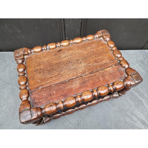 1065 - An 18th century oak reel turned stool, 46.5cm wide.