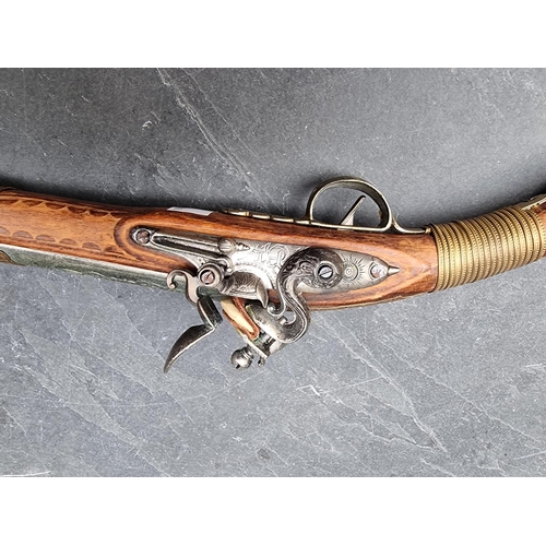 1170 - A reproduction flintlock musket; together with two similar pistols. (3)