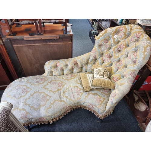 1079 - A Victorian button upholstered chaise longue, of shaped outline, approx 180cm wide.