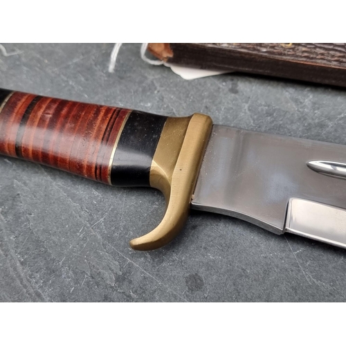 107 - A Down Under 'The Outback' knife and sheath, having 27.5cm blade.