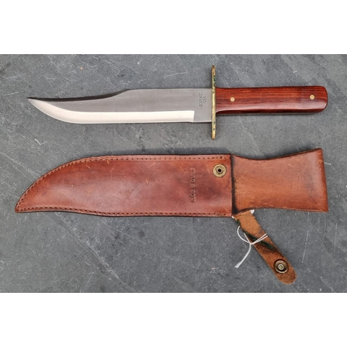 109 - A Bear & Son MGC knife and sheath, having 23cm blade.