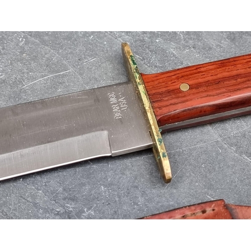 109 - A Bear & Son MGC knife and sheath, having 23cm blade.