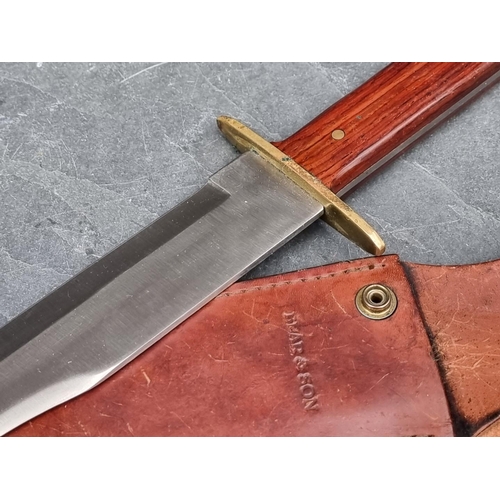 109 - A Bear & Son MGC knife and sheath, having 23cm blade.