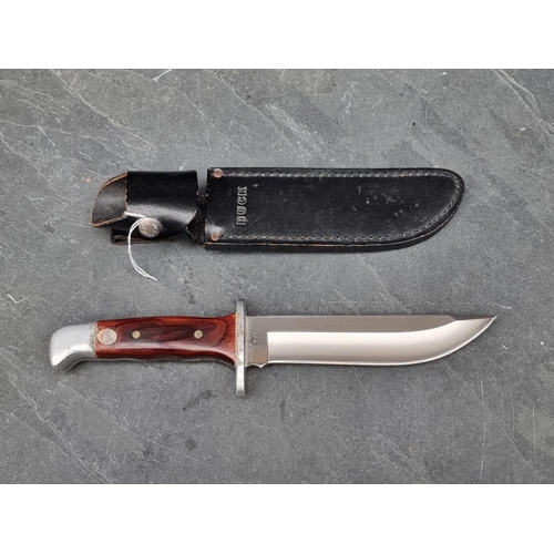 110 - A Buck 124 knife and sheath, having 17.5cm blade.