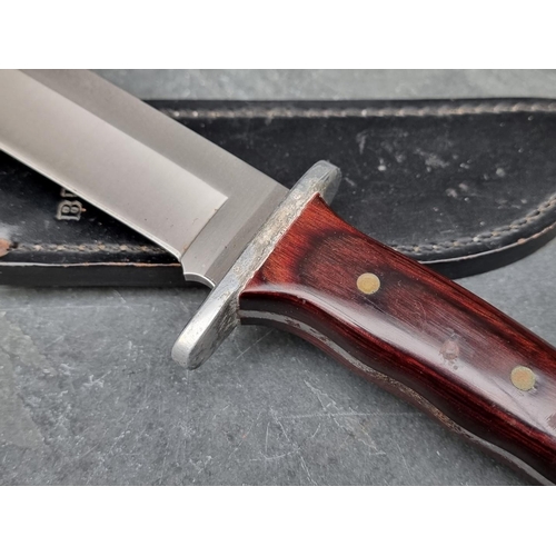 110 - A Buck 124 knife and sheath, having 17.5cm blade.