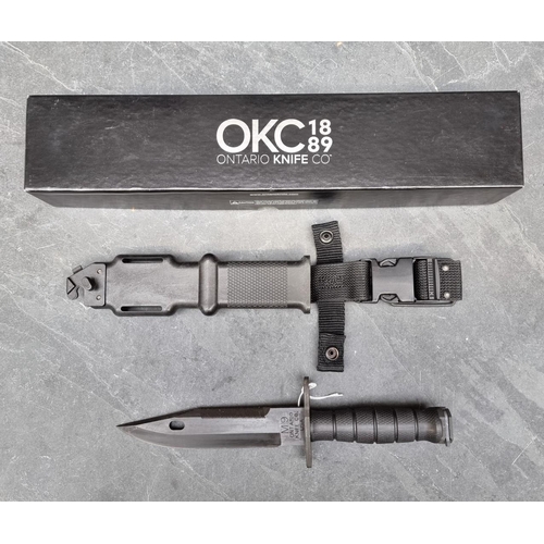 121 - An Ontario Knife Co. 'M9' knife and sheath, having 18cm blade, boxed.