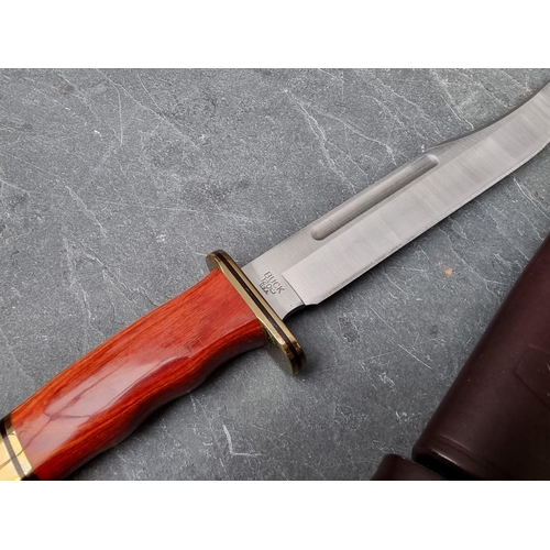 134 - A Buck 'Tops Knight Hawk 650' knife and sheath, having 15.8cm blade; together with a Buck '120' Bowi... 