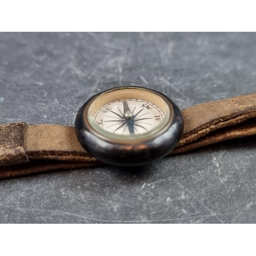 203 - A vintage wrist compass, 25mm, with leather strap.