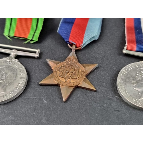 212 - Medals: a WWII group of six, to include: Atlantic Star; Italy Star and Defence Medal.... 