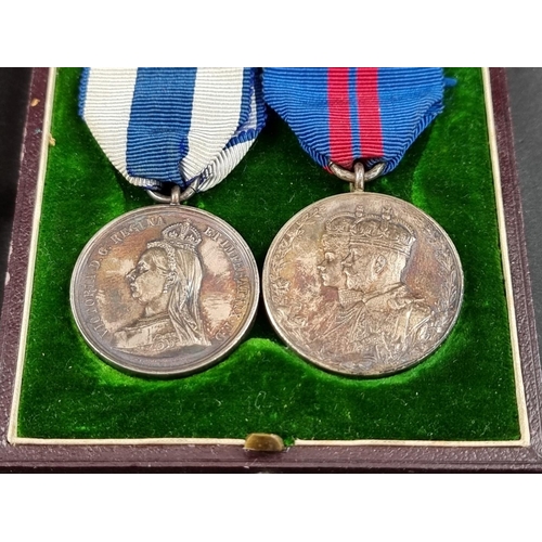 214 - A Victoria 1897 Jubilee Medal; together with a 1911 George V Coronation Medal, cased; and a matching... 