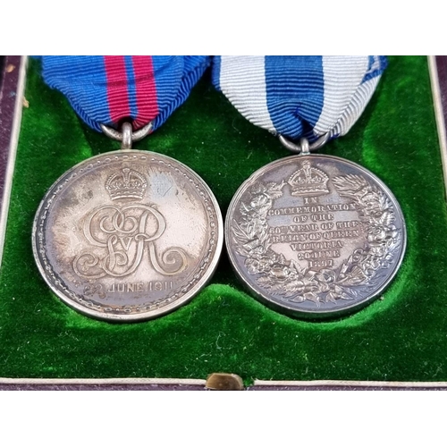 214 - A Victoria 1897 Jubilee Medal; together with a 1911 George V Coronation Medal, cased; and a matching... 