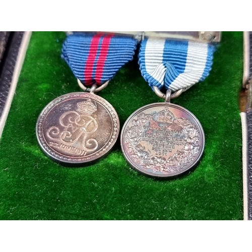 214 - A Victoria 1897 Jubilee Medal; together with a 1911 George V Coronation Medal, cased; and a matching... 