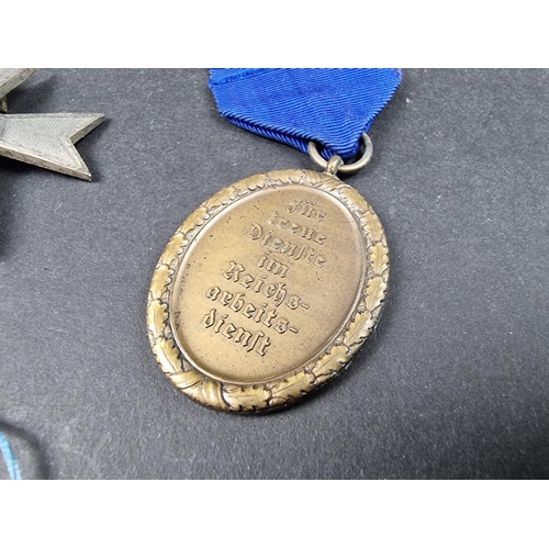 220 - A WWII German Iron cross; together with seven other German WWII medals and badges.