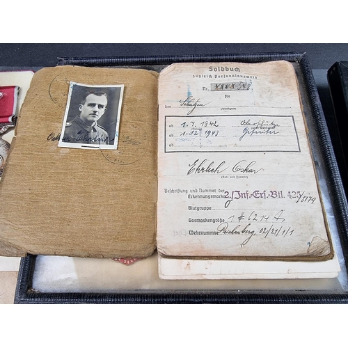 221 - A group of militaria and ephemera, to include; a framed group of five WWI British Red Cross medals, ... 