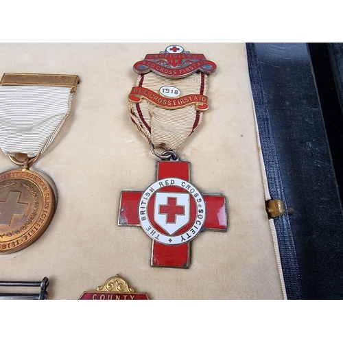 221 - A group of militaria and ephemera, to include; a framed group of five WWI British Red Cross medals, ... 