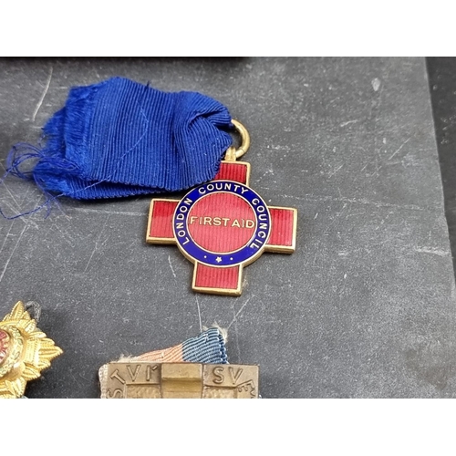 221 - A group of militaria and ephemera, to include; a framed group of five WWI British Red Cross medals, ... 