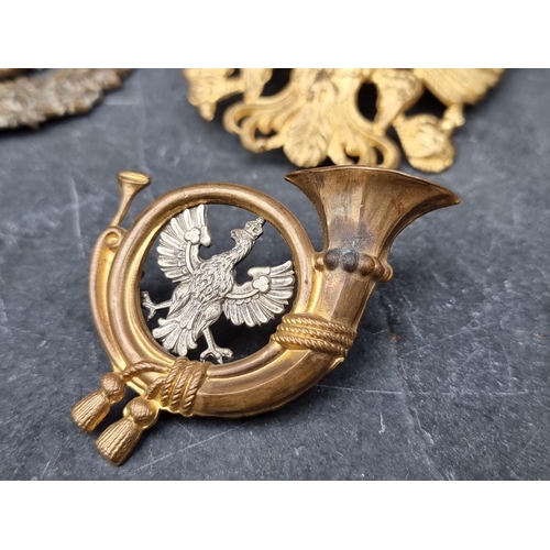 239 - A Prussian gilt metal pickelhaube helmet front badge, 9cm high; together with various other military... 