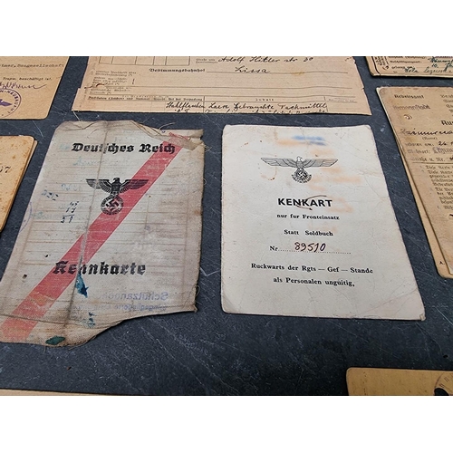 255 - A collection of German WWII identity cards, to include: Deutsche Reichsbahn and Polish worker exampl... 