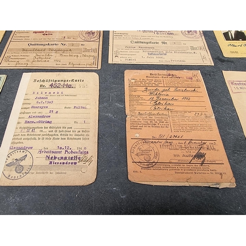 255 - A collection of German WWII identity cards, to include: Deutsche Reichsbahn and Polish worker exampl... 