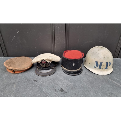 290 - A vintage French Kepi; together with two other hats; and a helmet. (4)