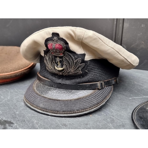 290 - A vintage French Kepi; together with two other hats; and a helmet. (4)