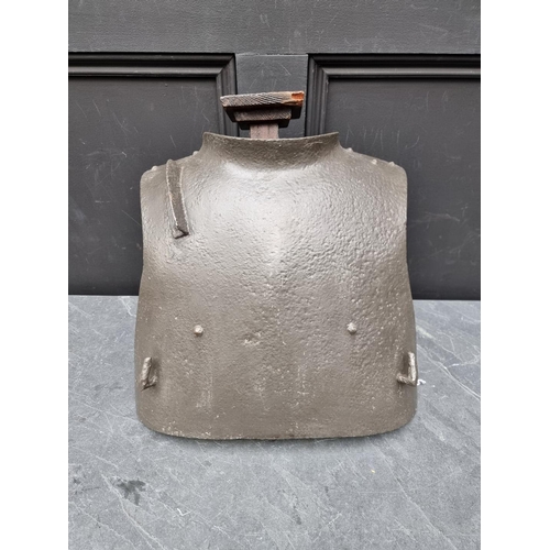 299 - A rare WWI German third model trench armour breast plate, approximately 35cm high, on a later wooden... 