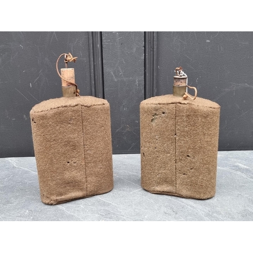 303 - Two WWII British army water canteens, both covered in khaki fabric, 21cm high including spout.... 