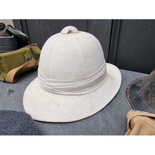 318 - A group of militaria; comprising a British gas mask, dated 1943; an RAF officer's peaked cap; an ARP... 