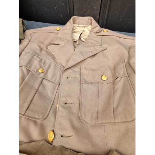 327 - A carton of mixed military clothing, to include a WWII US Navy deck jacket, (a.f.); coveralls e... 