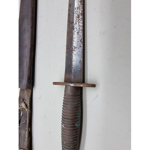 51 - A Fairbairn-Sykes type third pattern fighting knife and sheath, (s.d.).