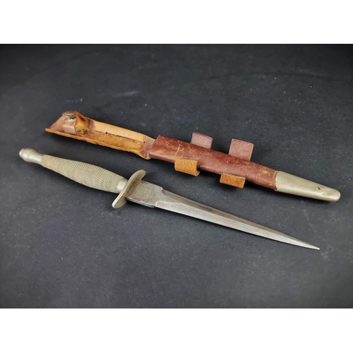 A rare circa 1940 Fairbairn-Sykes first pattern commando fighting knife and leather sheath, by Wilkinson Sword, the ricasso etched with makers mark to one side and 'The F-S Fighting Knife' to the other, with knurled grip, blade 16.8cm, overall 29.6cm.